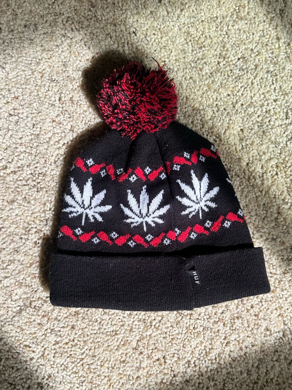 HUF Black Knit Pom Beanie with White Leaf Pattern and Red Trim